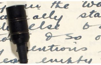 photograph of handwritten text and a pen