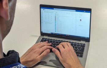 Sussex employee works at a laptop - using the MS Teams Calling functionality