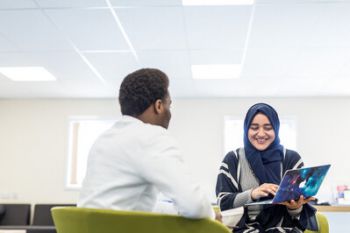 A photo of two students talking