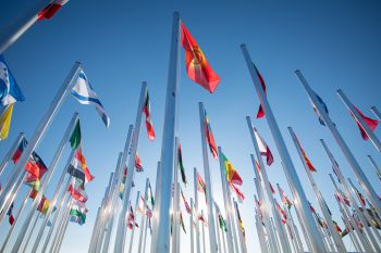 Multiple flag poles with the flags of UN members