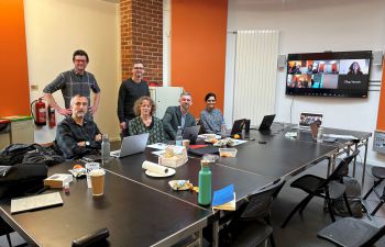 Group of academics around a meeting table