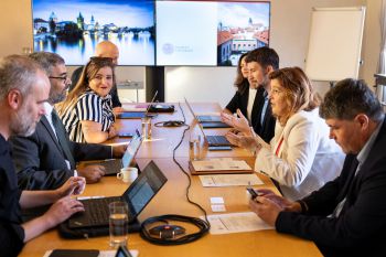 Sussex and Charles University colleagues sat around a meeting table