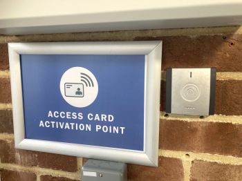 A photo of an access card activation point, with blue signage