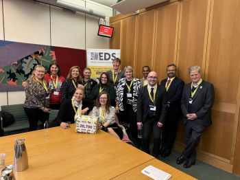 Group photo of the team in a room at Portcullis House