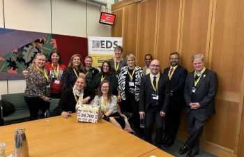 Group photo of the team in a room at Portcullis House