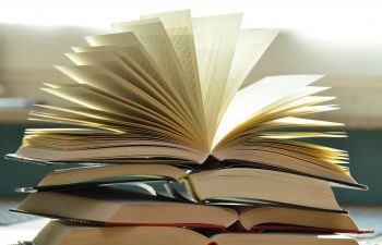 Open books in a pile