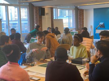 Groups of people sat at tables in discussion