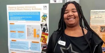 Myisha, smiling, standing next to her JRA poster which is on display