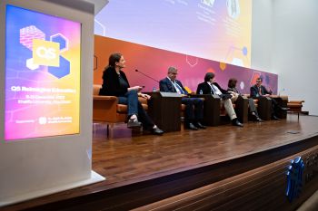 Five panellists sat on a stage