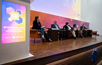 Five panellists sat on a stage