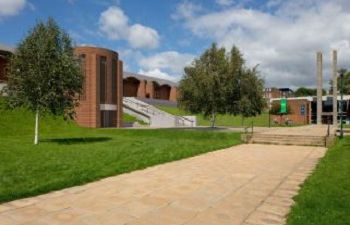 An image showing the proposed new Library entrance including a new brick tower containing a lift and a new ramp along the top of the Library's grassy bank