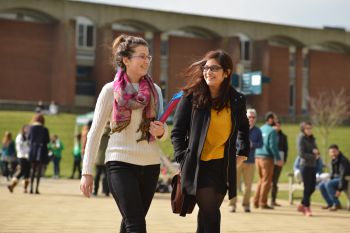 Students walking across library square on campus