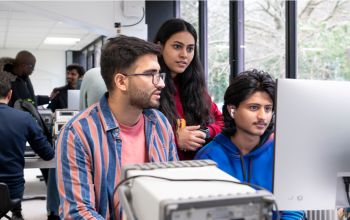 Students working around a computer