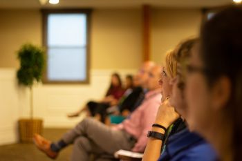 image of a woman in the front row of a talk