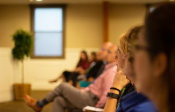 image of a woman in the front row of a talk