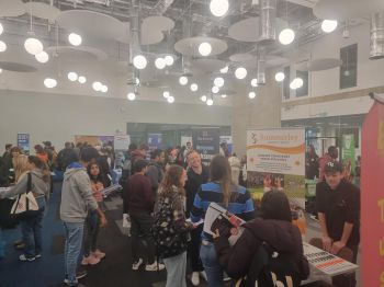 Students walking around stalls at the summer jobs fair