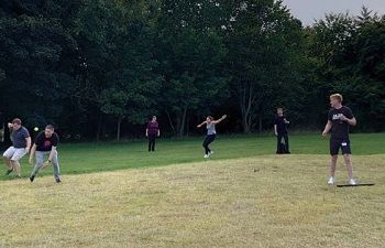 Staff playing sport outside