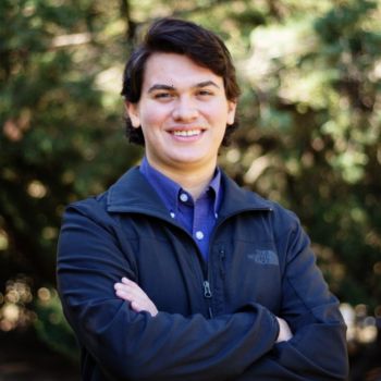 Photo of Jorge, dark hair wearing a dark blue jacket