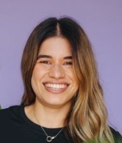 Headshot of Ximena wearing a black shirt, long hair