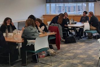 Two groups of people sitting at tables