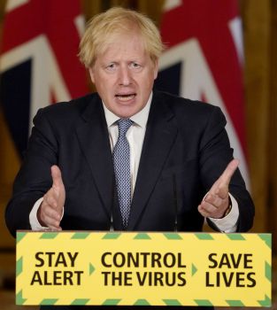 Photo of Boris Johnson standing in front of a podium that say