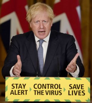 Photo of Boris Johnson standing in front of a podium that say 