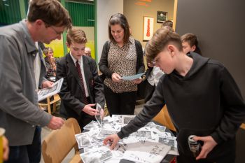 Ben Burbridge from Sussex with young man and his mum, looking at ‘zines they made as part of the workshops