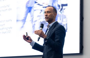 Photograph of double winner of Startup Sussex 2024, Shuaib Karmani, pitching at the grand final