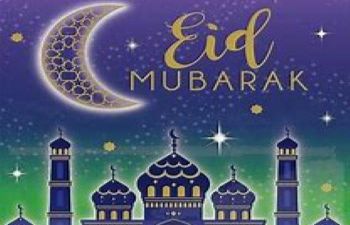 Image of the crescent moon over buildings with gold lettering 'Eid Mubarak'