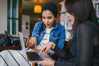 Two woman looking at a laptop screen