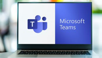 A laptop screen showing the Microsoft Teams logo with the text 'Microsoft Teams'