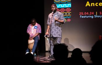 Chevening Scholar and writer Namse Udosen stands on stage at ACCA
