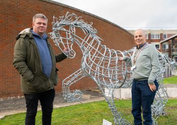 Image of two men standing next to the Gypsy cob-horse