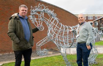 Image of two men standing next to the Gypsy cob-horse