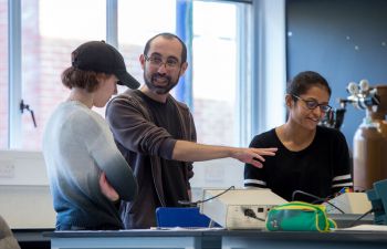 Staff and students in a physics teaching lab