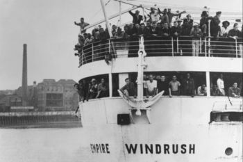 Black and white photograph of HNT Empire Windrush with people aboard