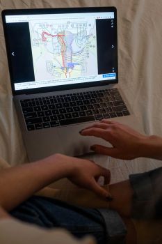 A laptop screen with two hands next to the keyboard showing an illustration of the female anatomy