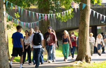 Students walking on campus on a sunny day