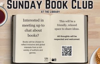 An open book with text promoting the club with the focused text reading 