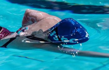 Swimmer with a Sussex swimming cap on