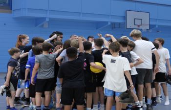 a group of children in a huddle having a team talk