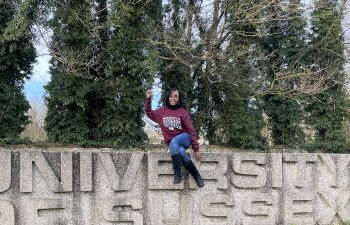 Thokozani Makuyana sat atop the University of Sussex sign