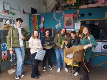 Group of students in a workshop smiling at the camera