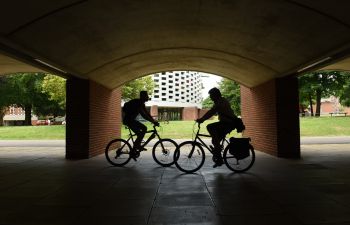 Two cyclists on their bike on campus
