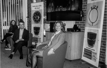 Black and white image of two people sitting in armchairs