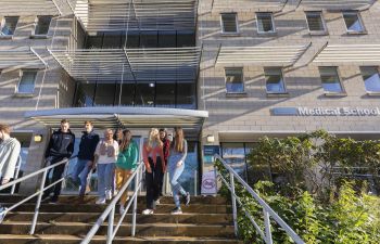 a group of BSMS students outside the teaching building on the Sussex campus