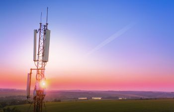 Image of phone mast with sun setting in background