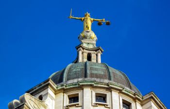 Image showing Lady Justice on top of The Old Bailey with blue sky