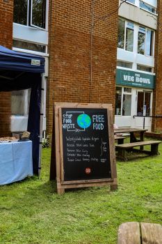 An A-board outside a pop-up food stall that's advertising 'Stop Food Waste'