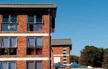 Student residences in front of a bright blue sky